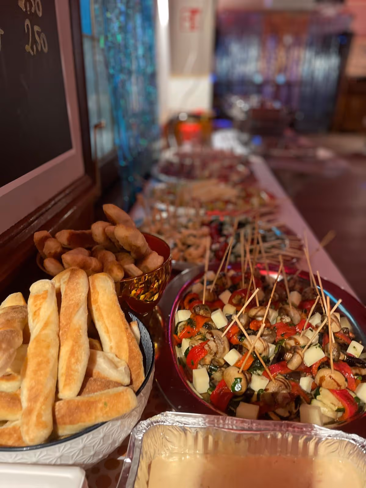 Buffet mit Brotstangen, Fingerfood und Salatspießen.